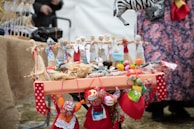 A table full of creative crafts made by day centre members, showing vibrant colors.