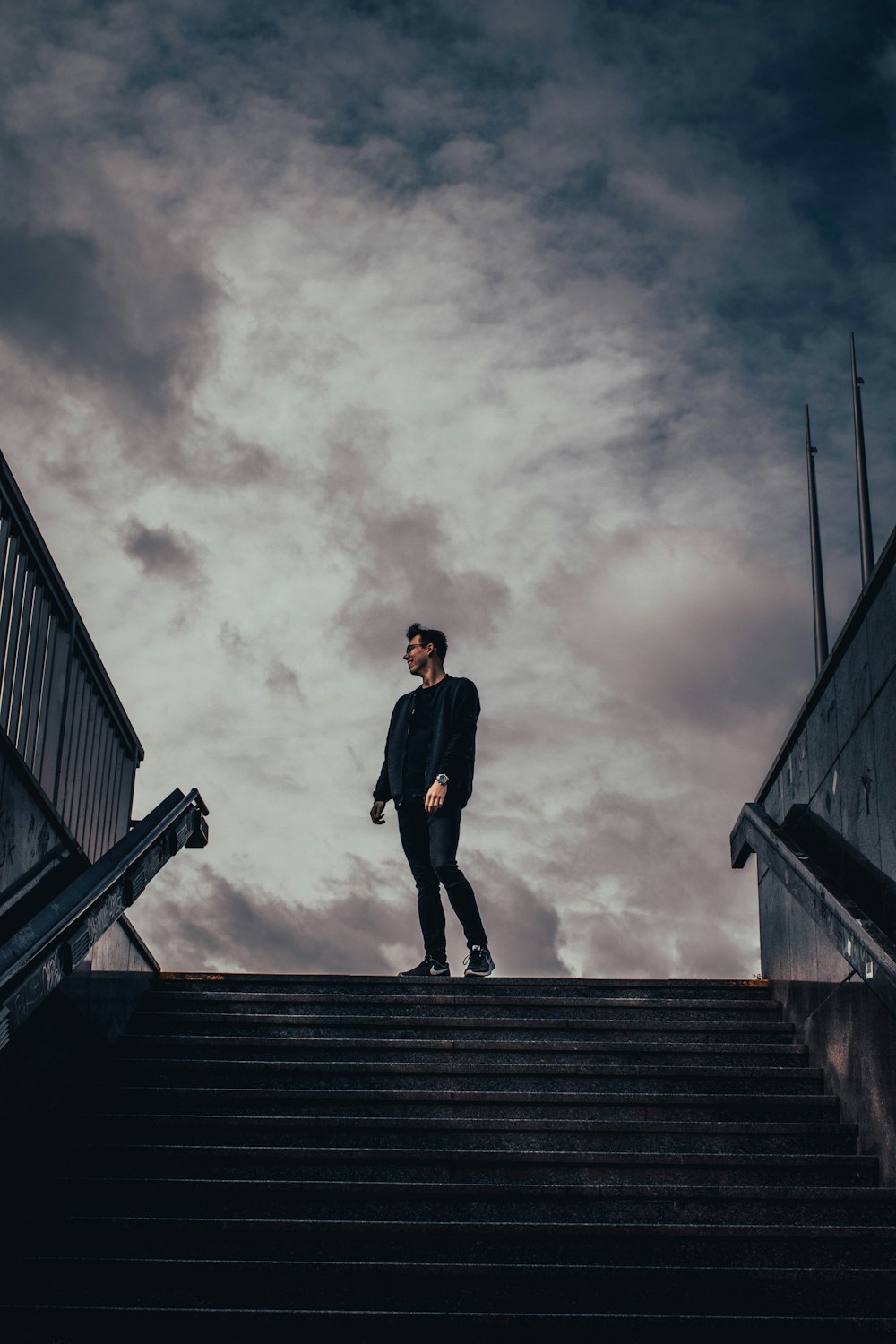 man standing beside staircase