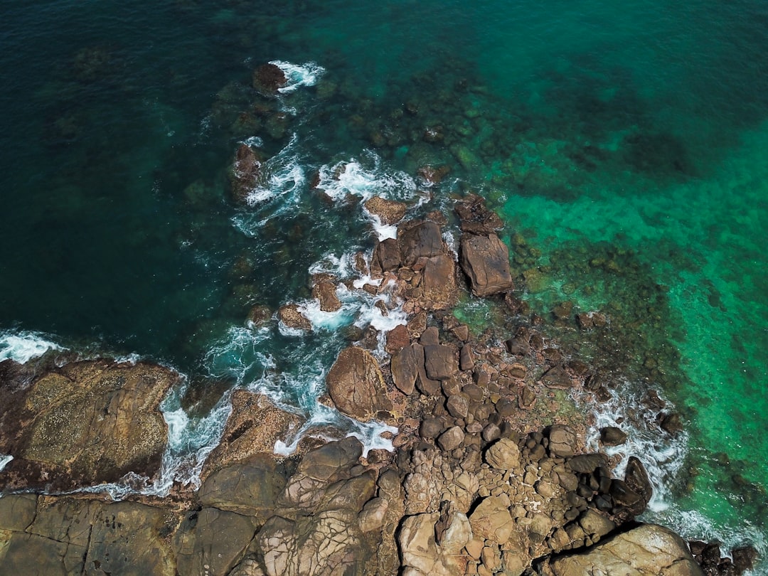 aerial view of mountain and body of water