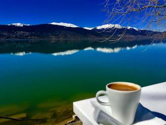 Guests enjoying a peaceful morning coffee on the bungalow terrace with lake view.