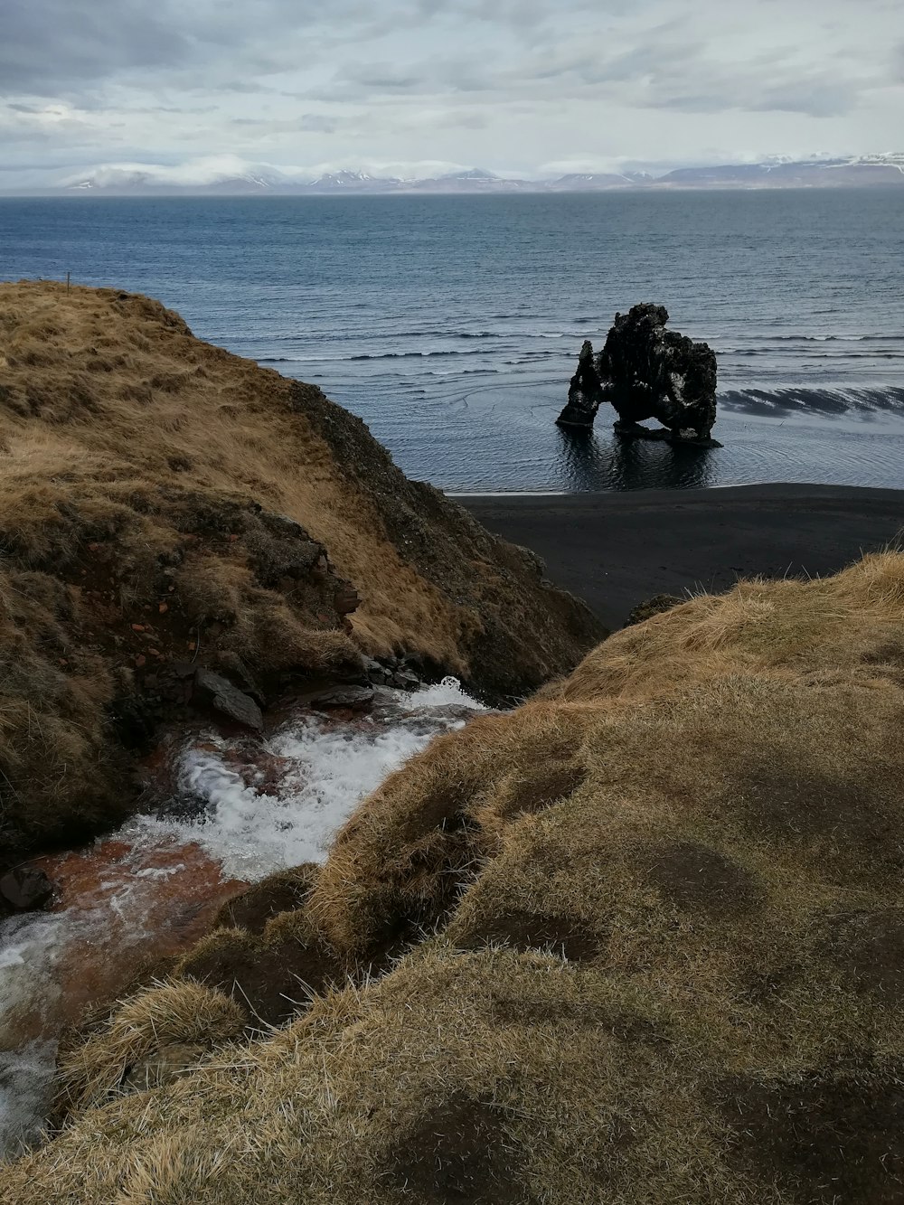 brown rock formation near sea