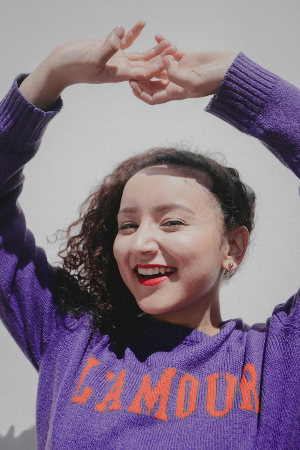 girl in purple sweater smiling