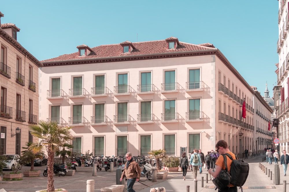 people near concrete building during daytime