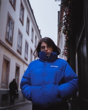 shallow focus photo of woman in blue full-zip bubble jacket