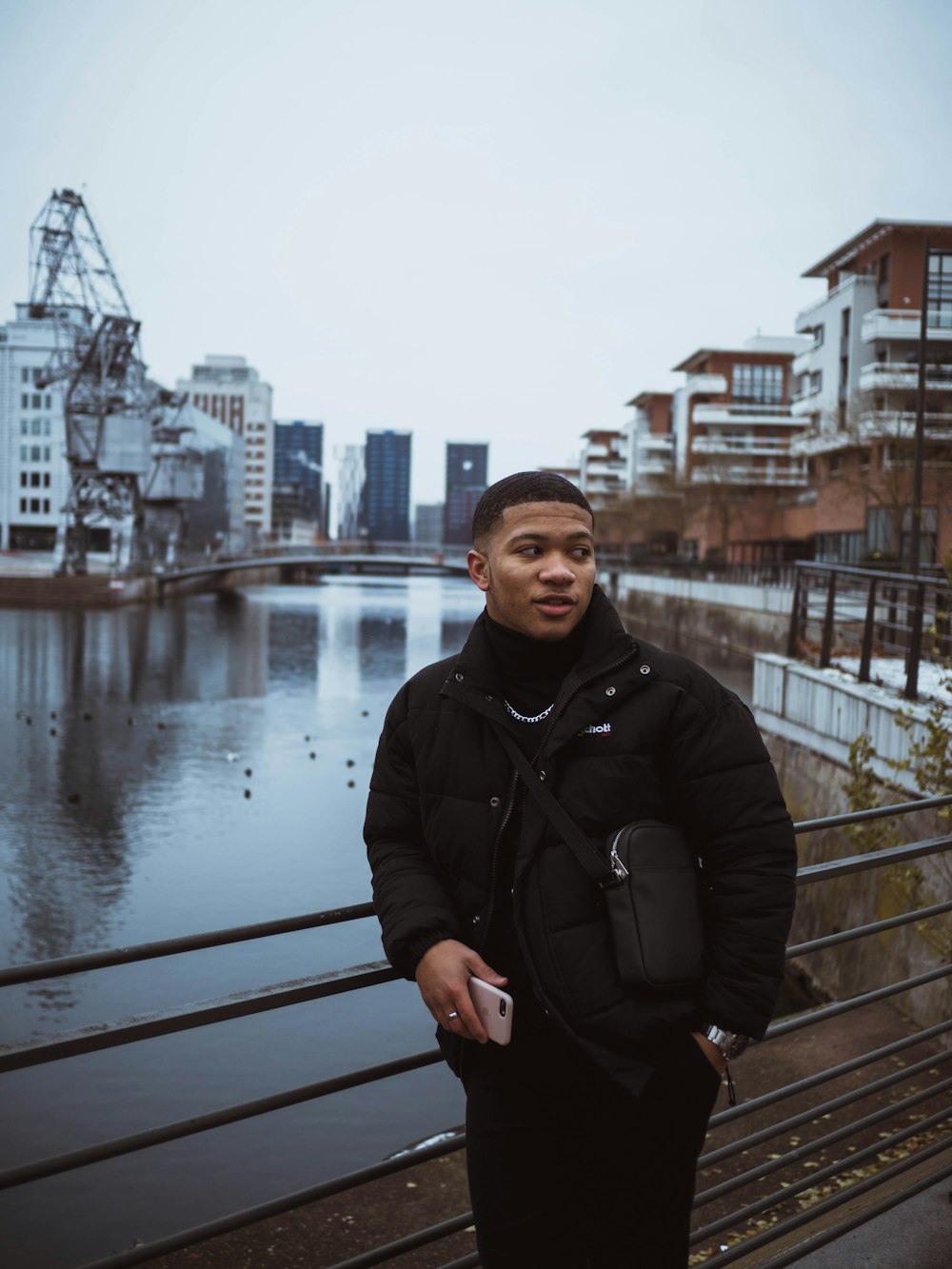 man leaning on metal bars