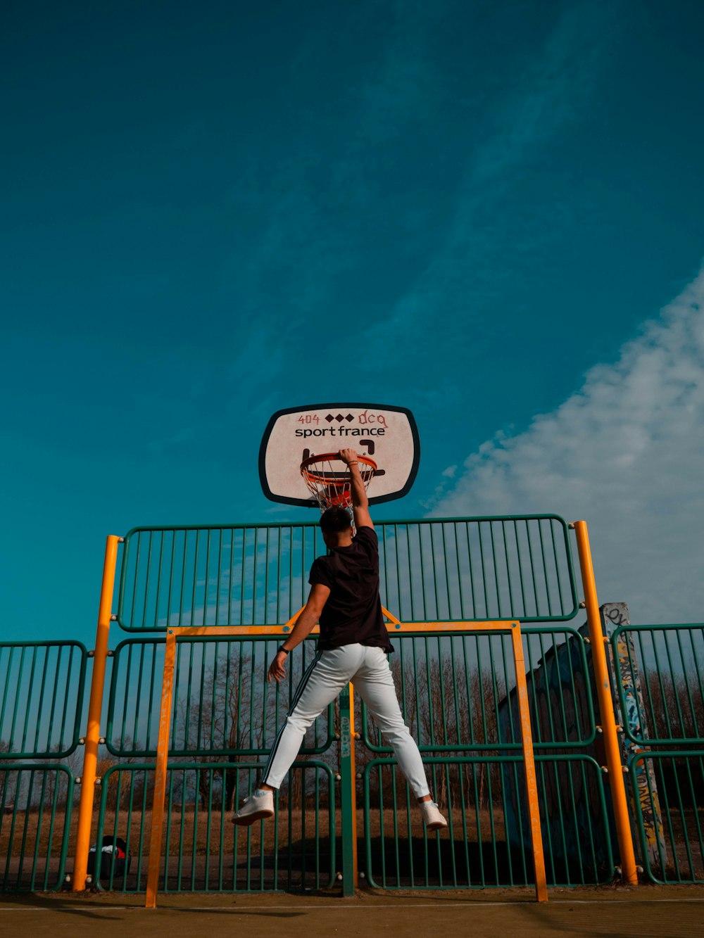 man dunking on basketball hoop