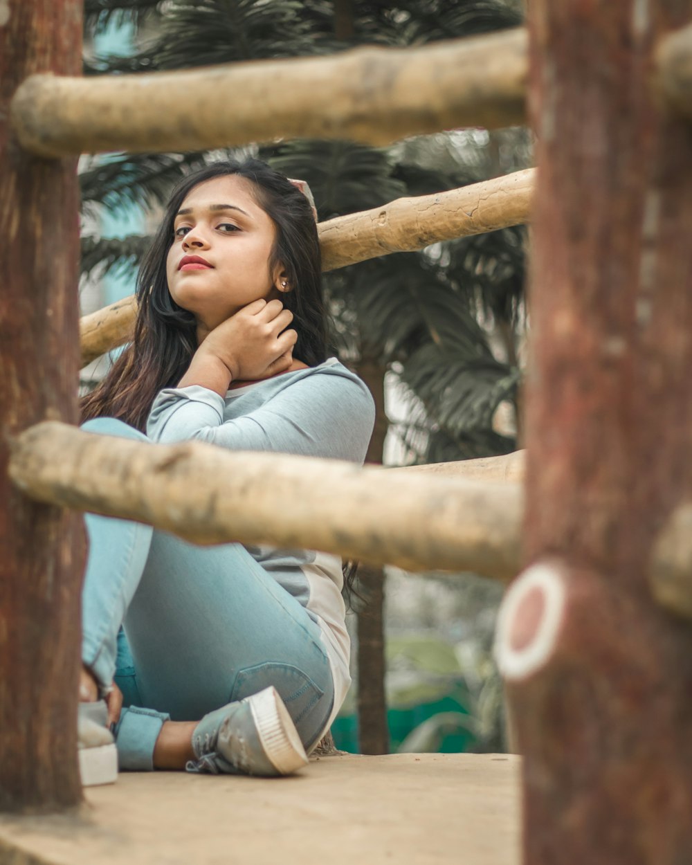 woman sits on bridge