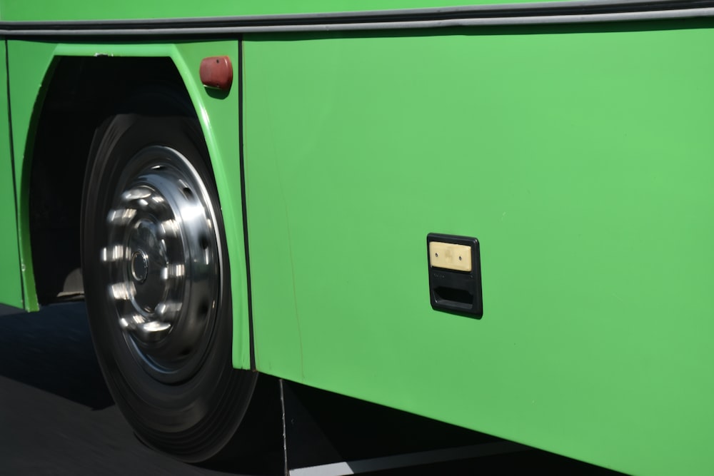a close up of a green bus tire