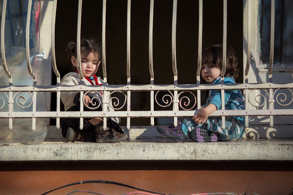 two children sitting on floo