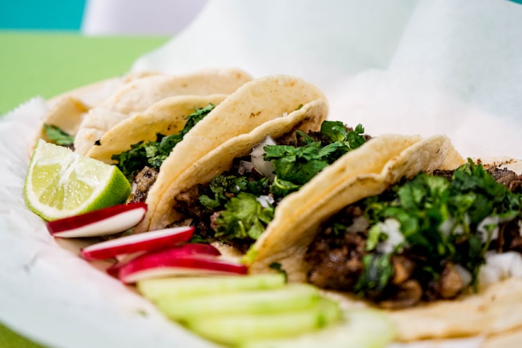 Plate of soft shell tacos with cilantro and meat