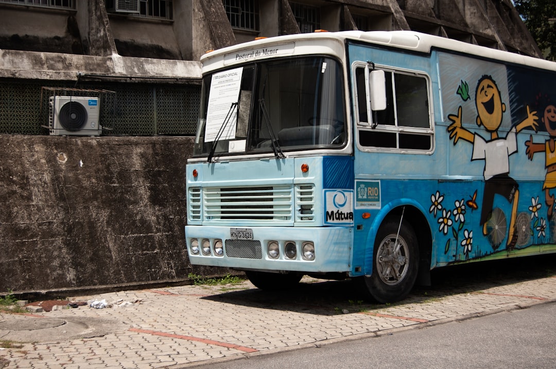 blue bus on sidewalk