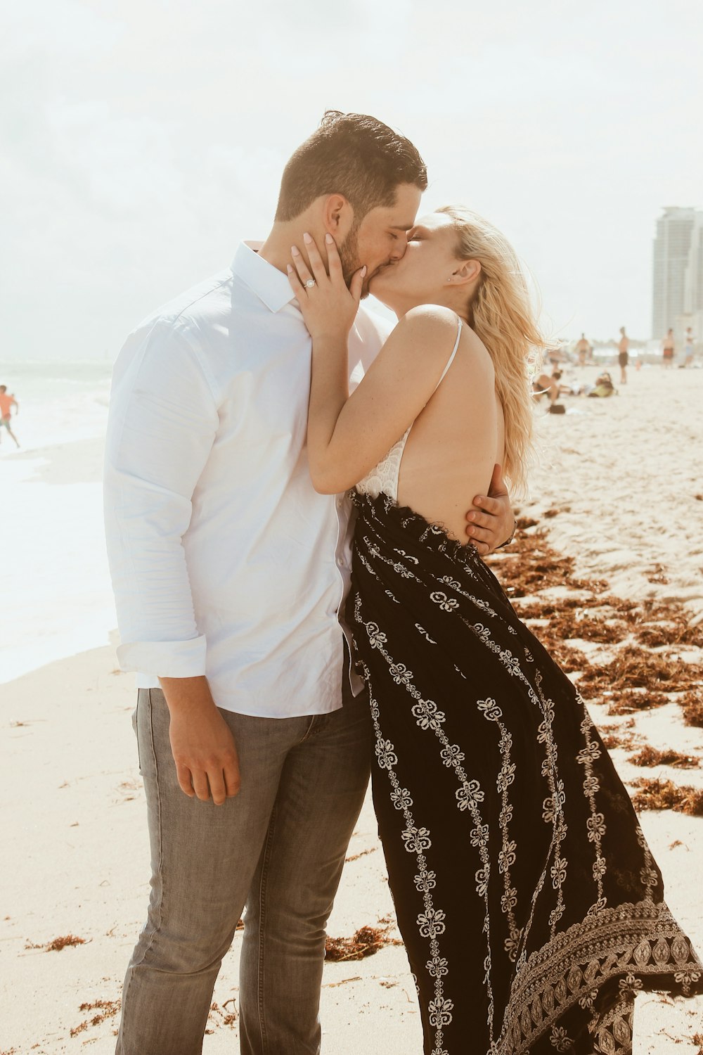 man and woman kissing on shore