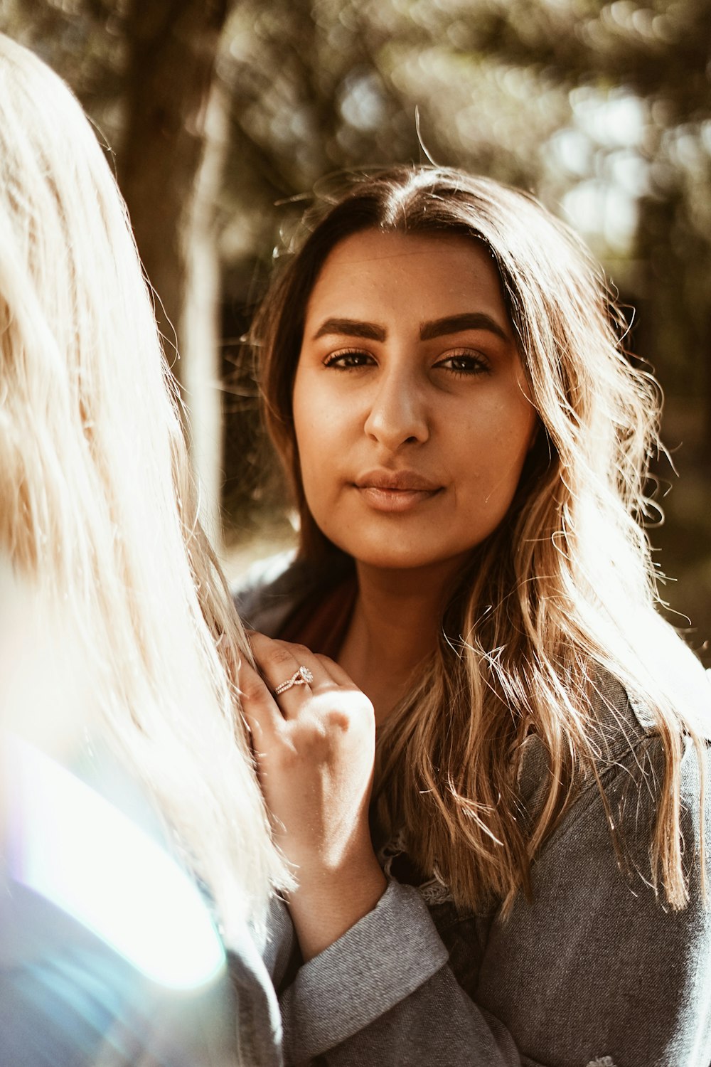 woman standing near woman in white top