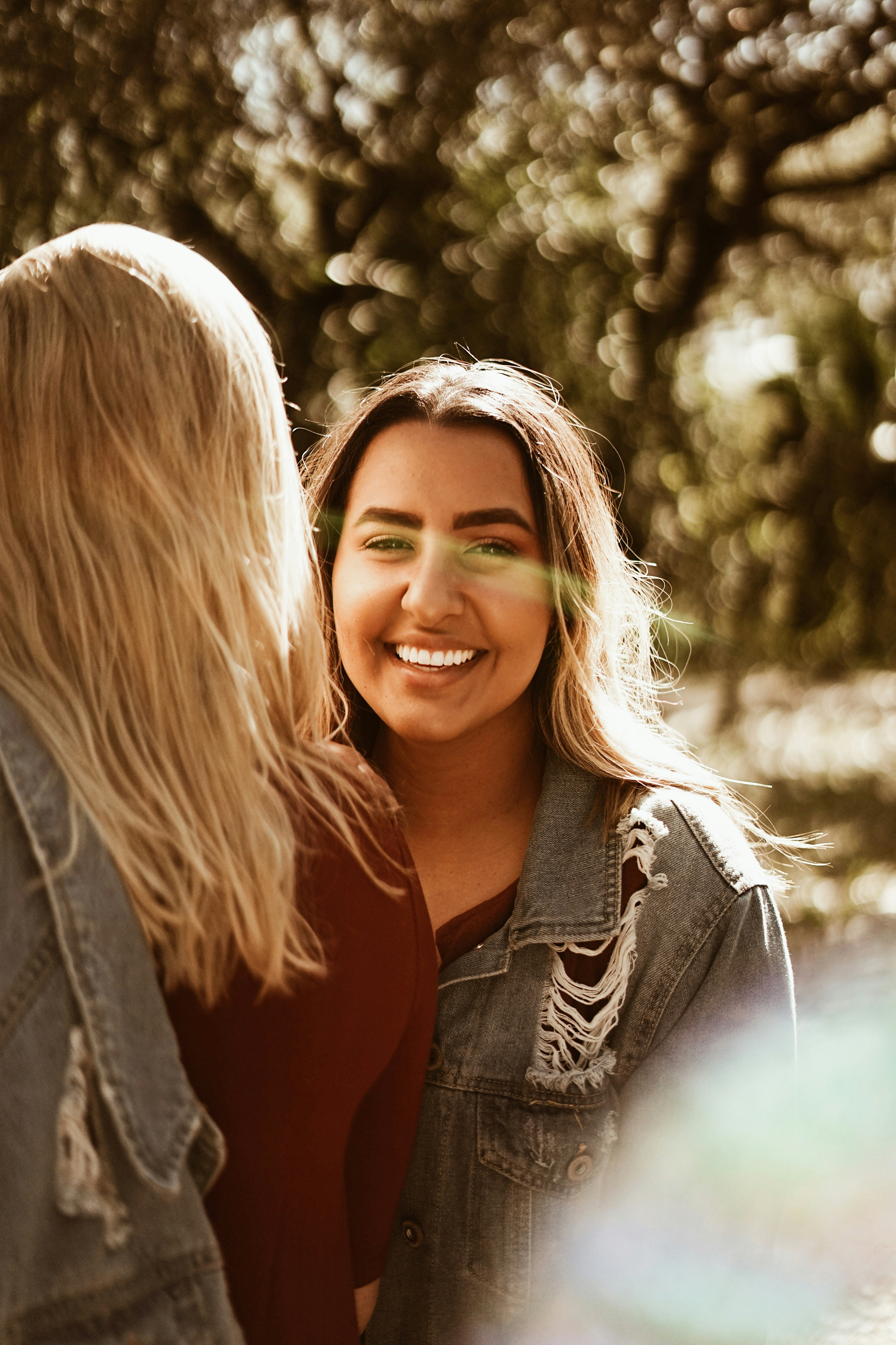 smiling woman wearing denim jacket