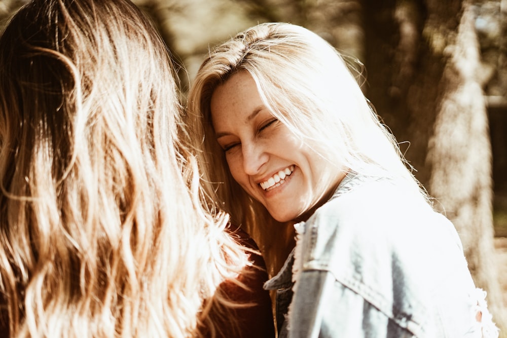 smiling woman wearing blue denim jeans