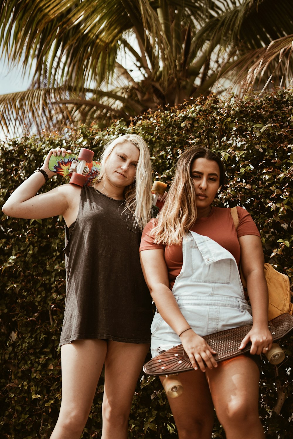 two women holding skateboards