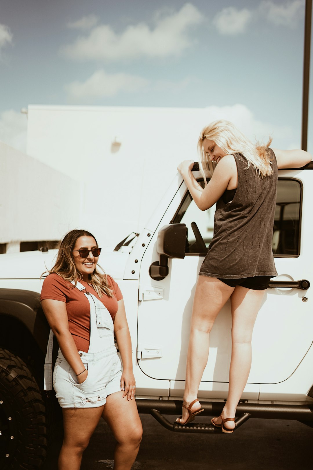 man standing beside woman on white vehicle