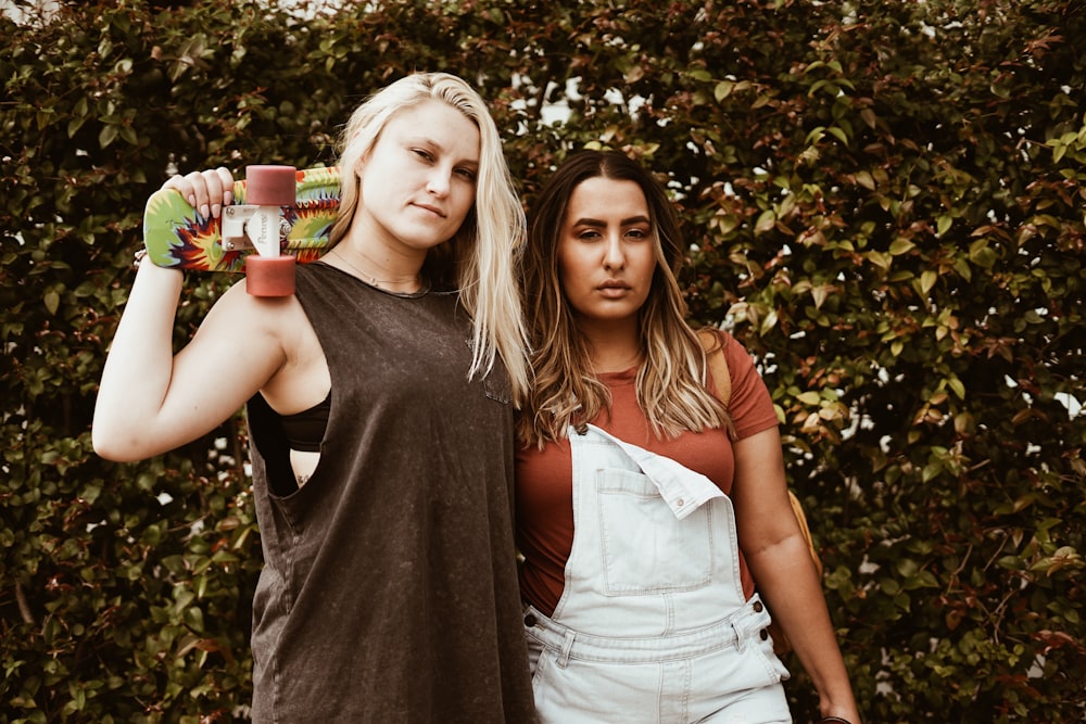 two women with arms around their waists