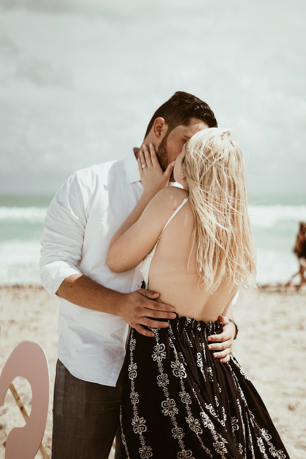 coupe kissing during daytime near beach