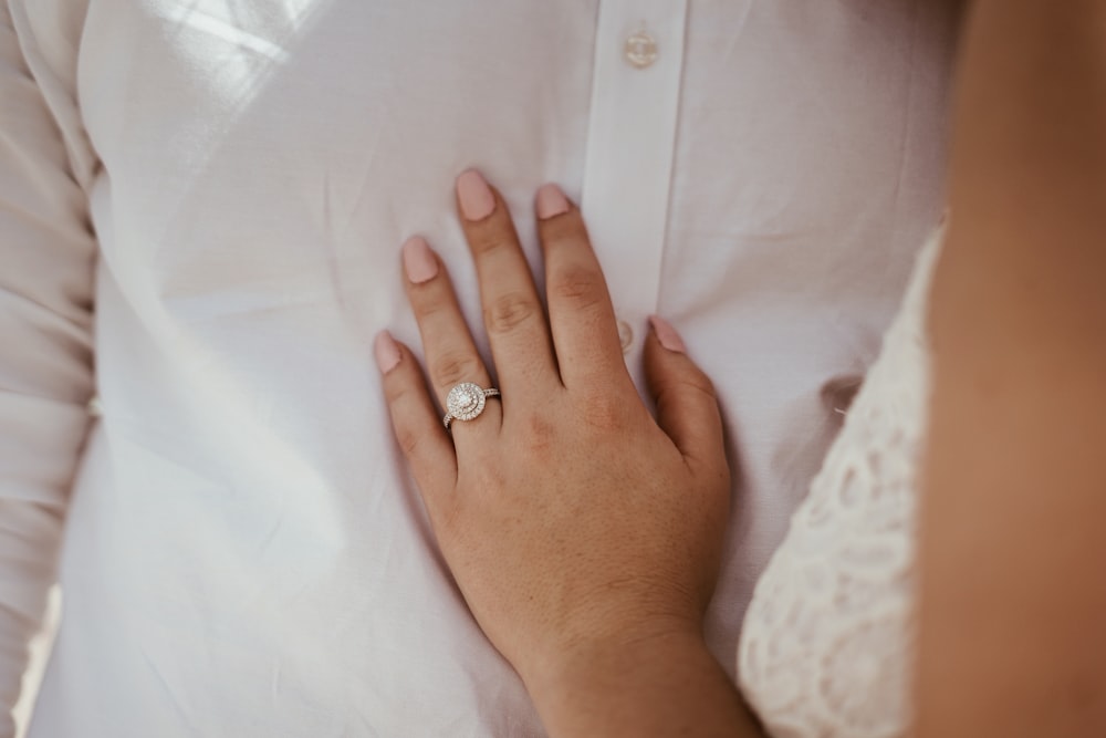 woman touching white dress shirt