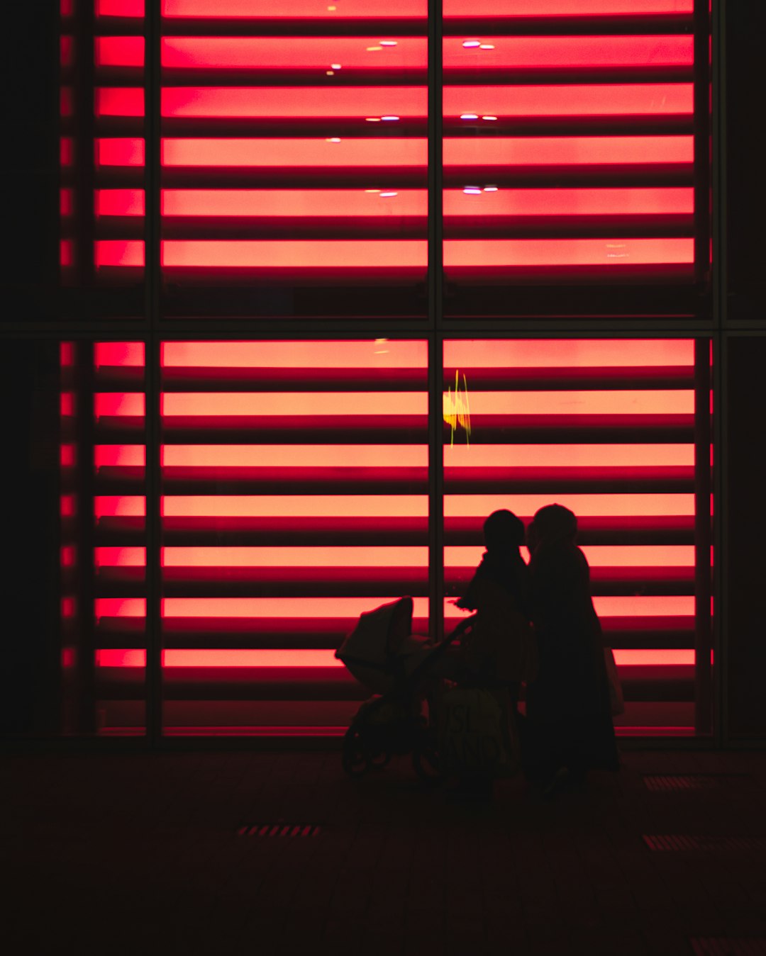red lighted window blinds
