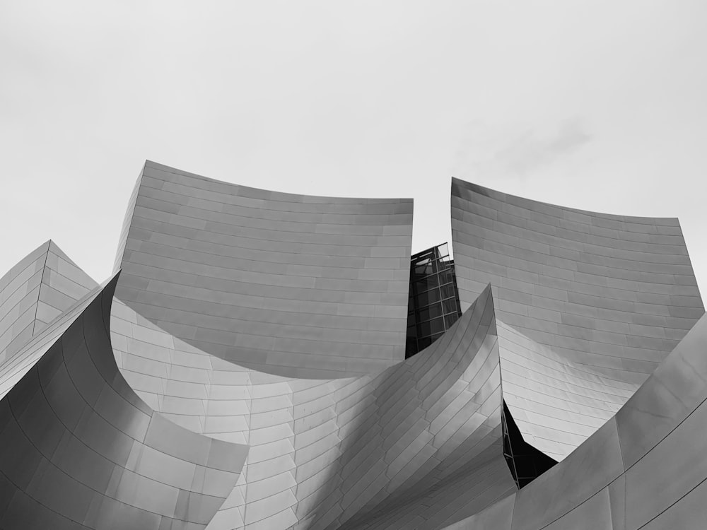 grayscale photography of low angle photography of concrete building during daytime