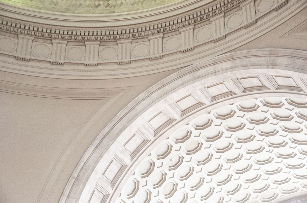 the ceiling of a building with a clock on it