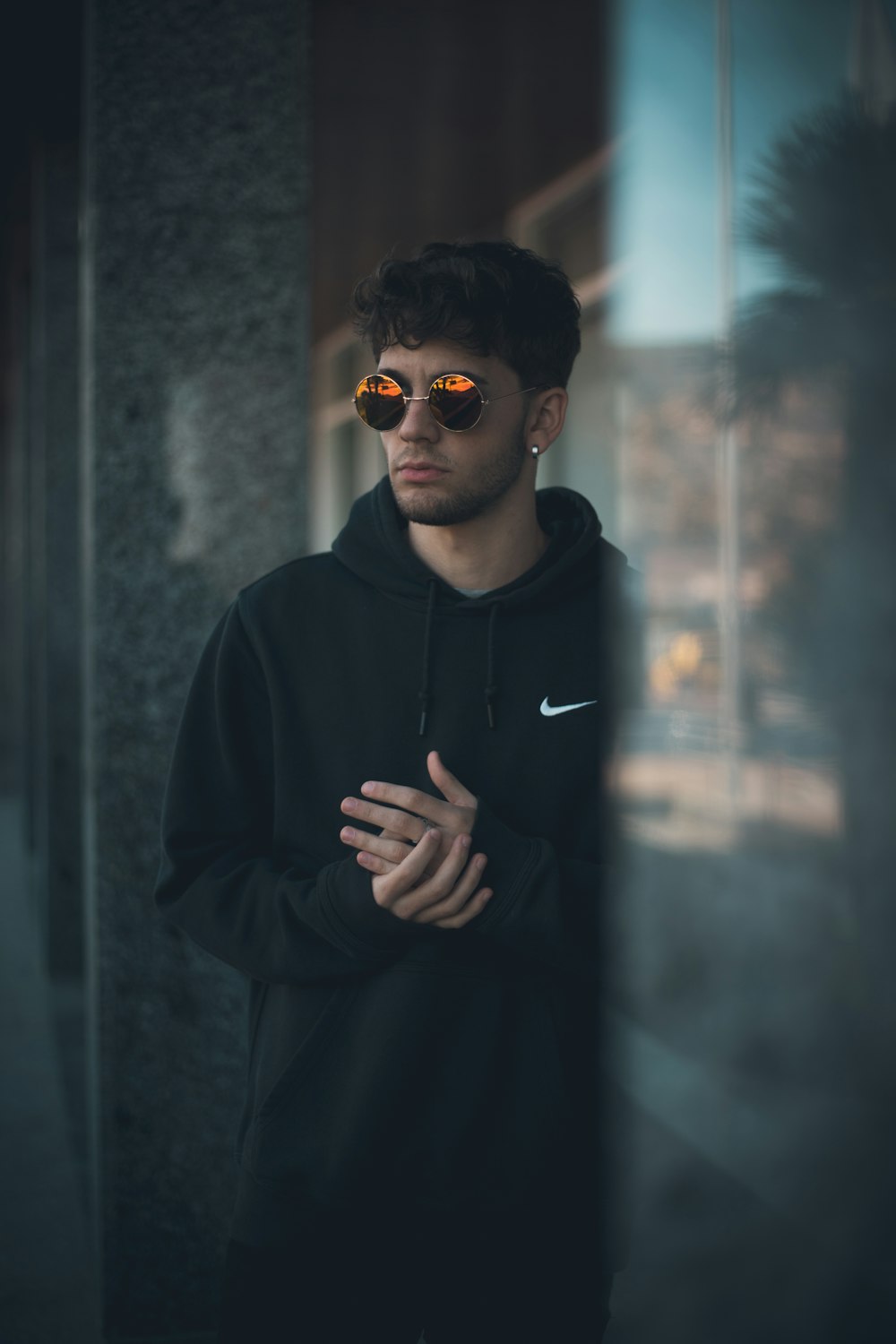 man wearing black Nike pullover hoodie