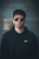 man standing wearing black Nike hoodie