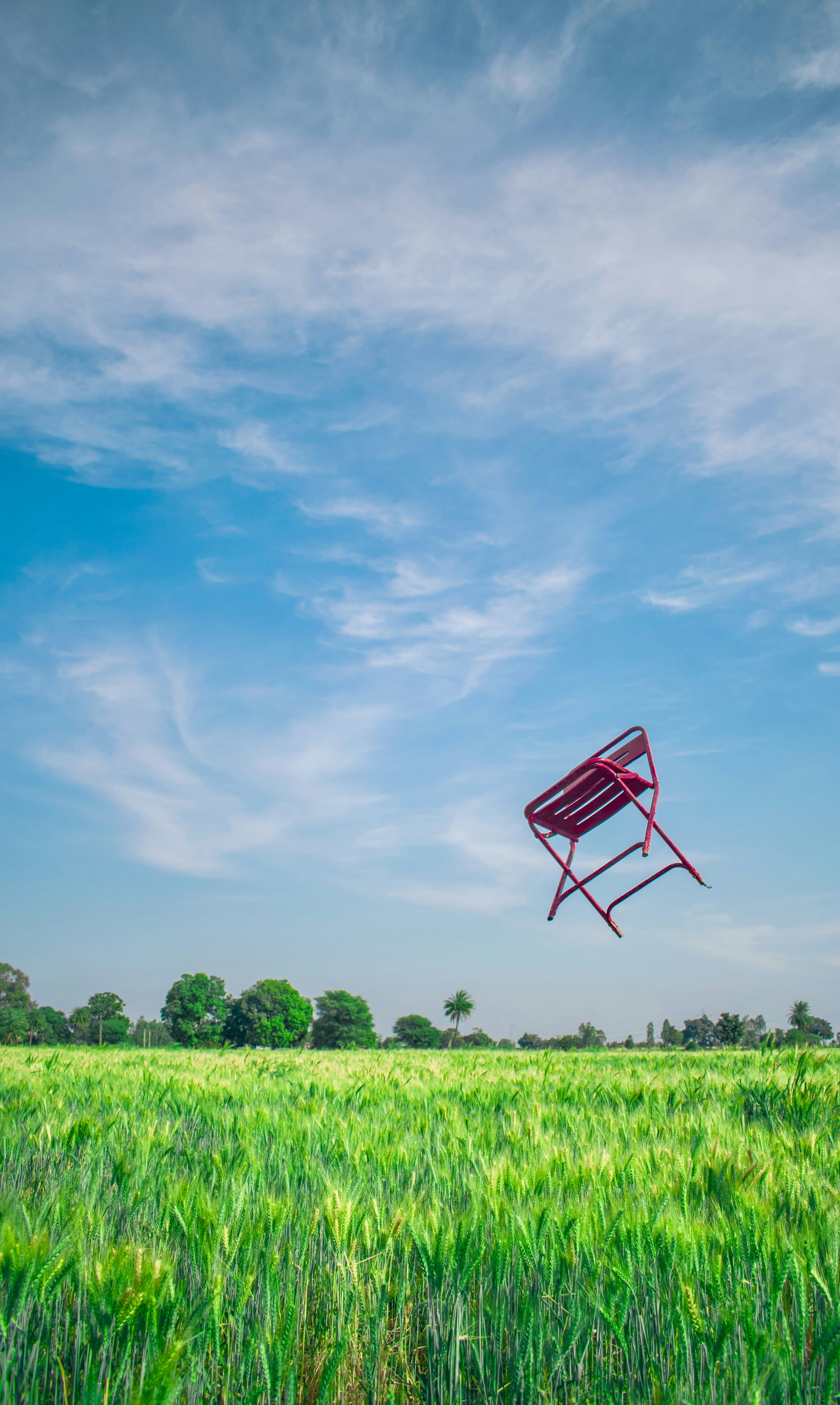 Red chair throw over the grass photo Free Blue Image on Unsplash
