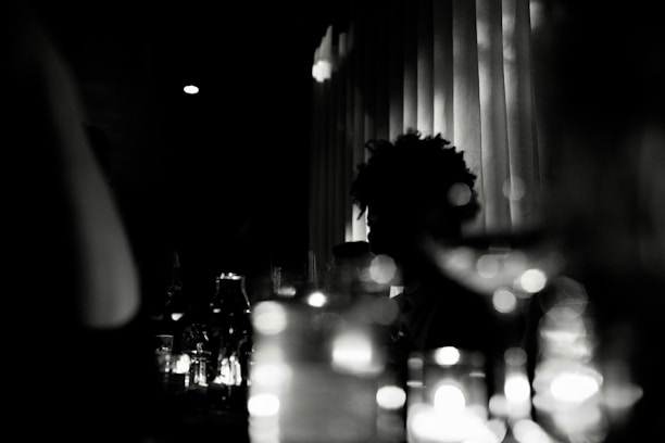 A tasteful, dimly lit scene with sensual silhouettes suggesting intimacy.