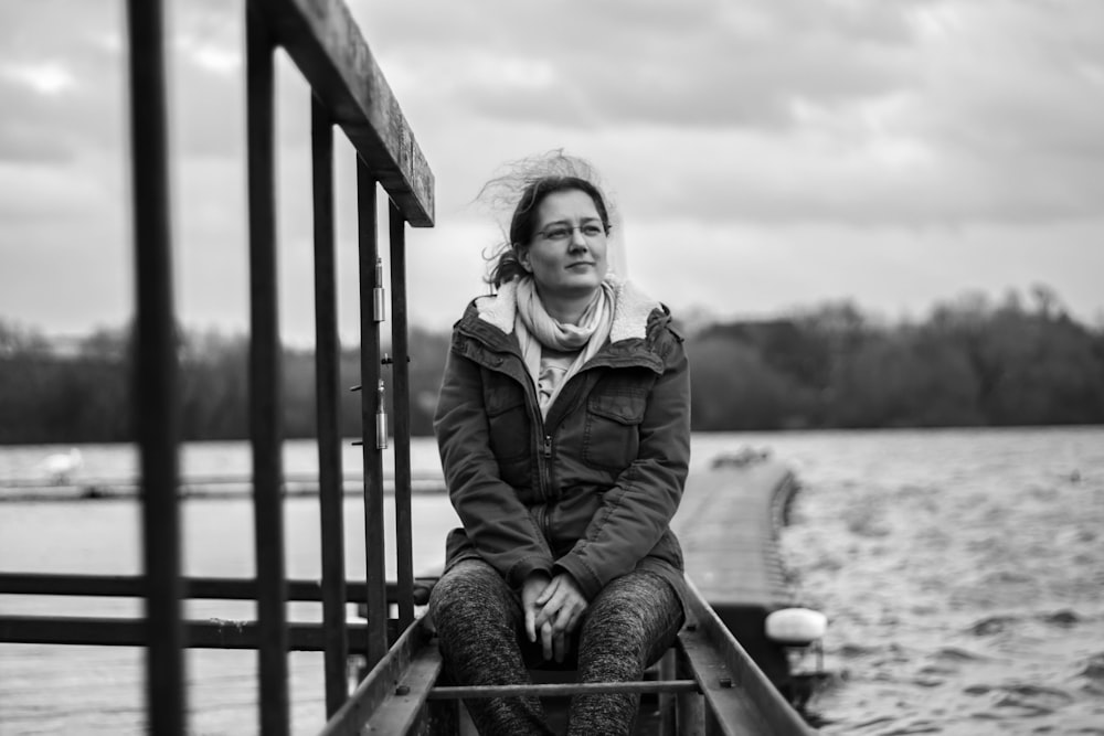 grayscale photography of woman sitting