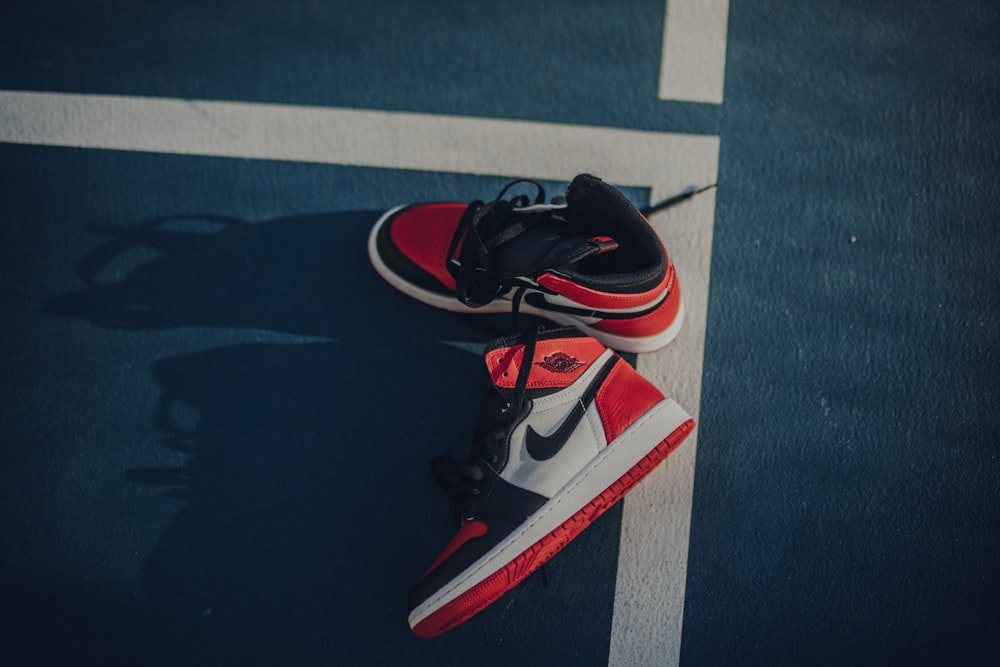 pair of white-black-and-red Air Jordan 1's