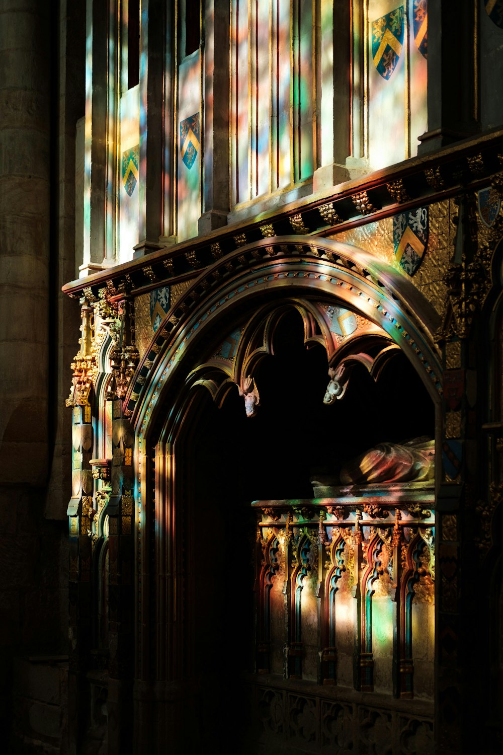 a church with stained glass windows and a wooden railing