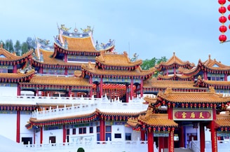 Traditional Chinese temple with intricate roof details surrounded by autumn foliage.