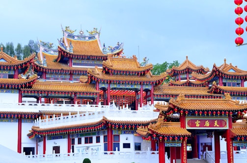 Traditional Chinese temple with intricate roof details surrounded by autumn foliage.