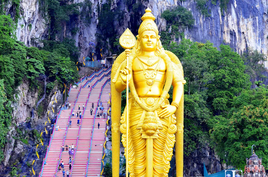 Batu Caves stairway and golden statue — a steady flow of millions of visitors yearly
