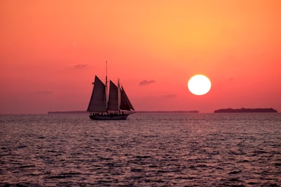 white sailboat on ocean boat teams background