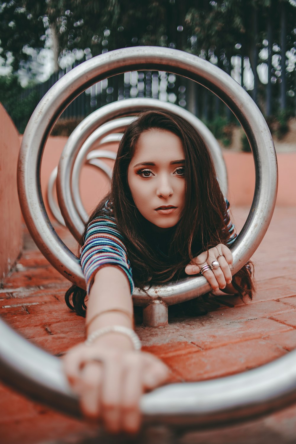 woman crawling on round gray metal bar