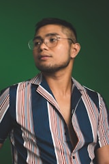 man in button-up T-shirt and eyeglasses