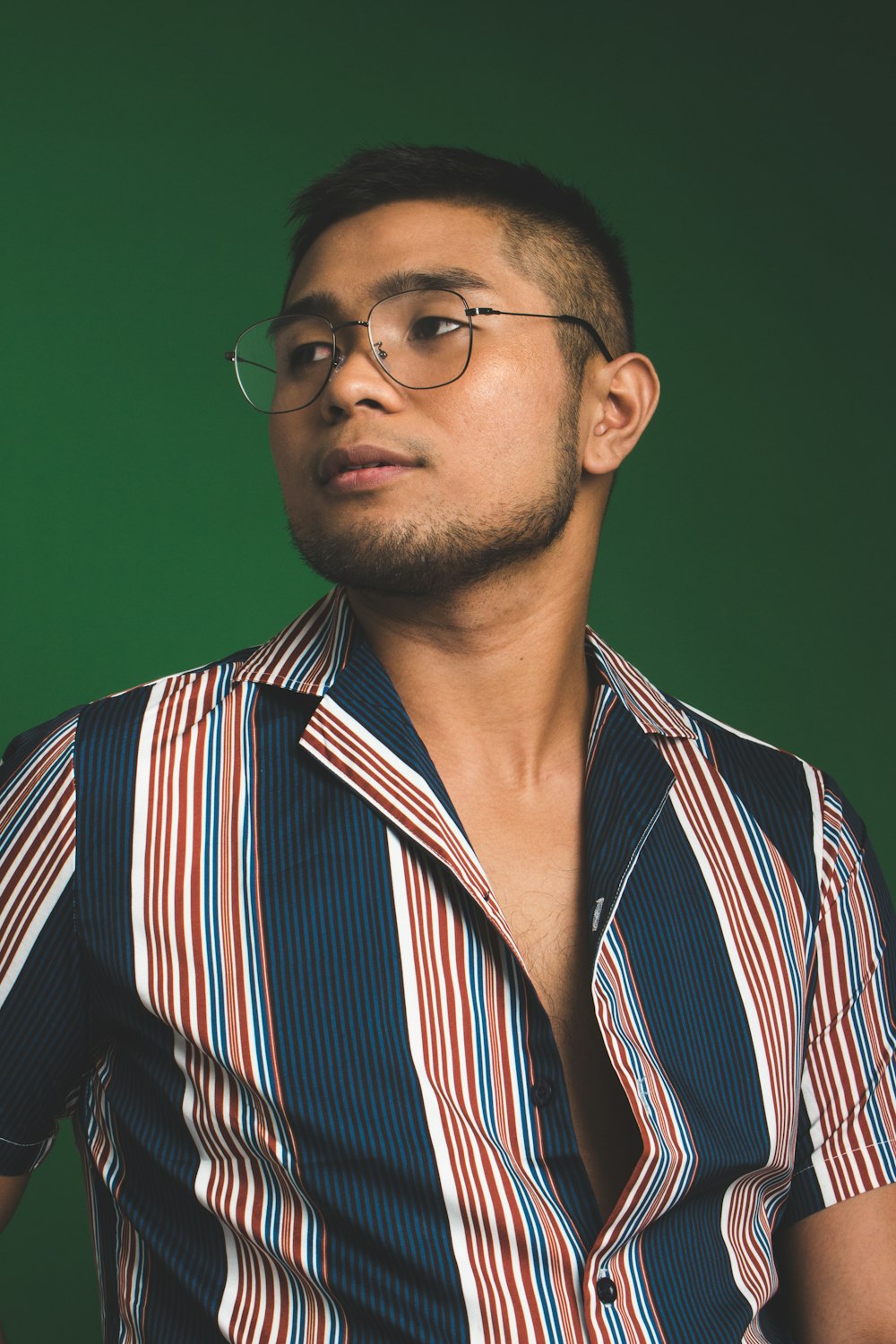 man in button-up T-shirt and eyeglasses