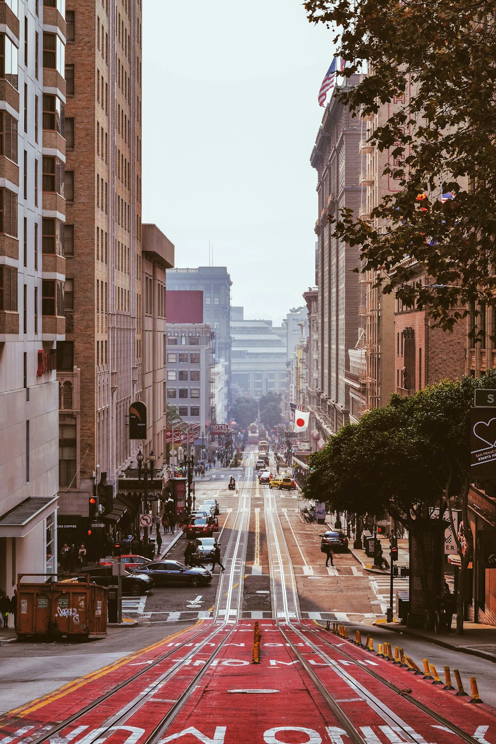 red and grey road between buildings during daytime