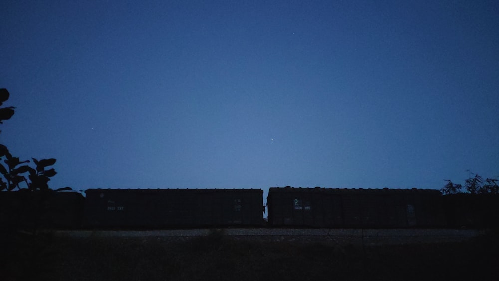 a train traveling down train tracks under a blue sky