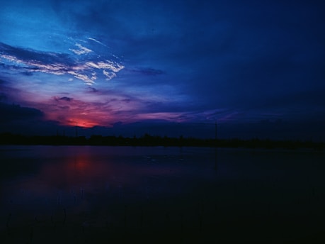 A beautiful sunset over a calm lake.