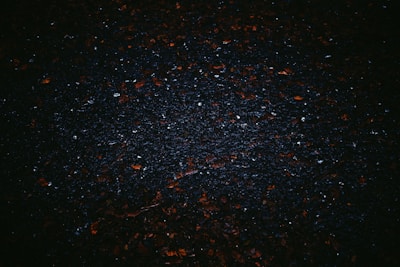 a black background with small red and white speckles
