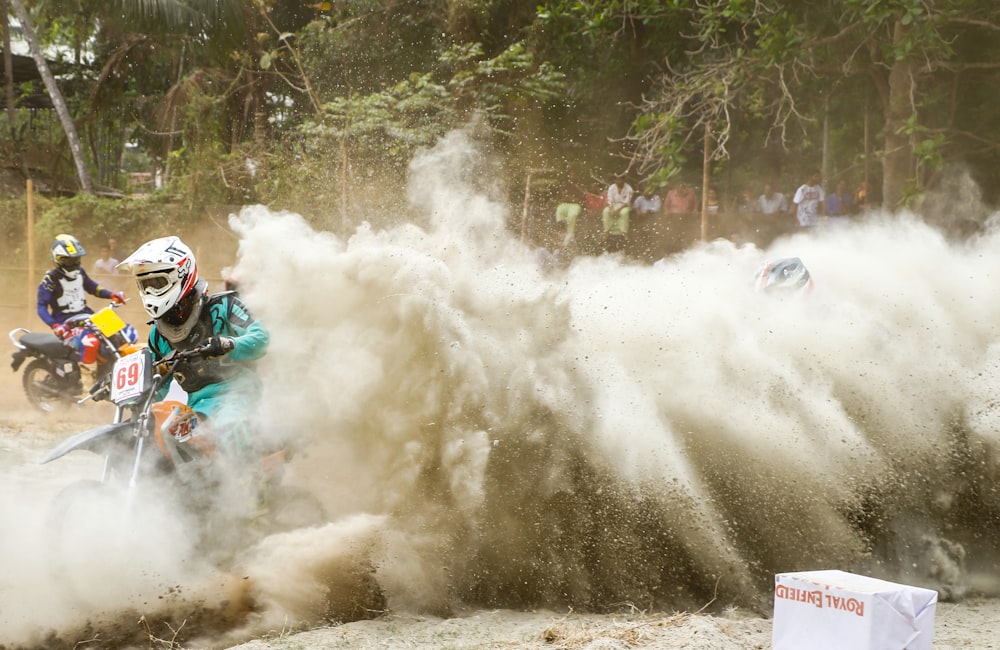 person riding on dirt bikes