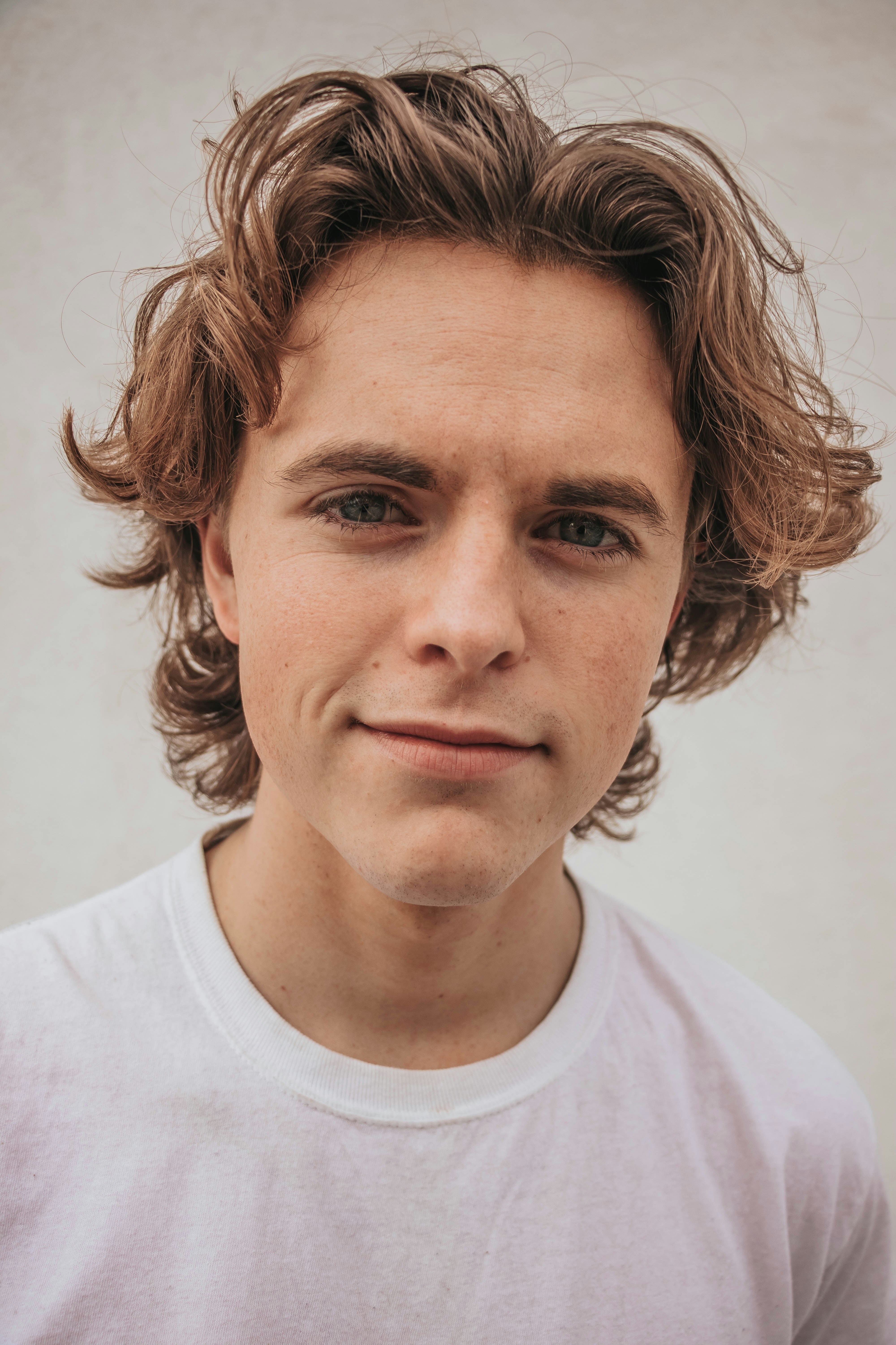 smiling man in white crew-neck shirt