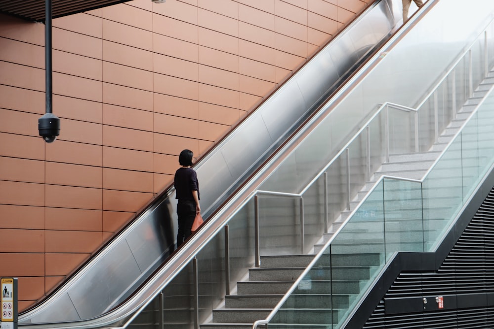 woman on an escalator going up