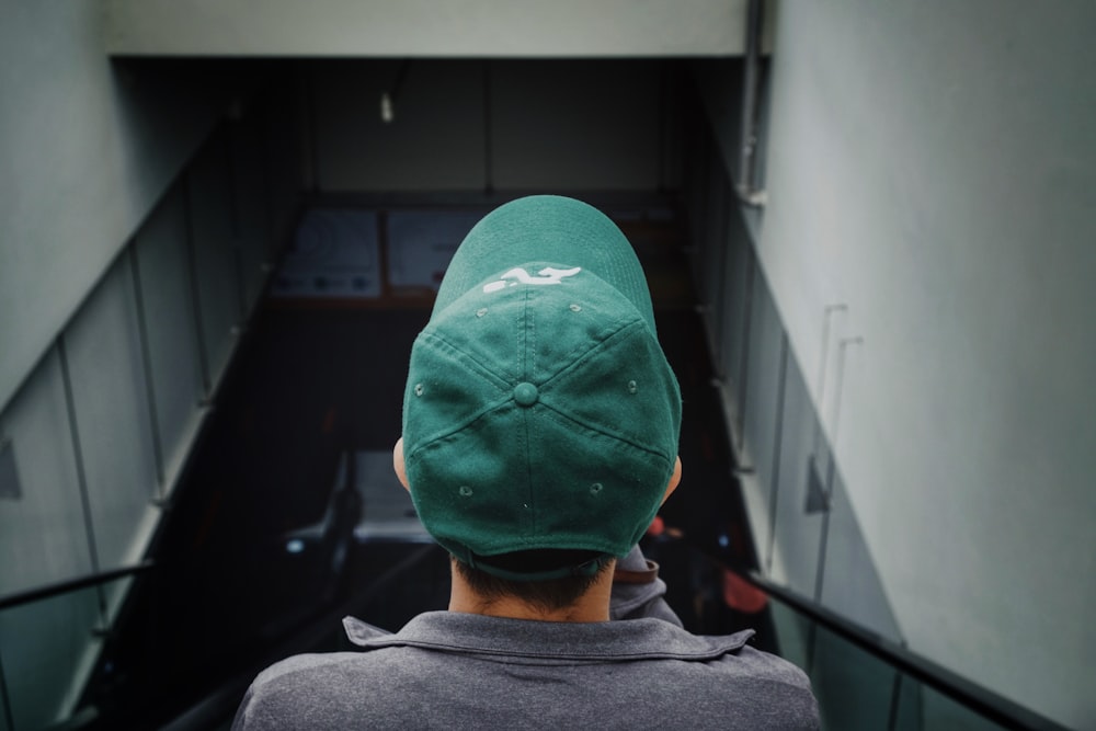 man wearing green cap