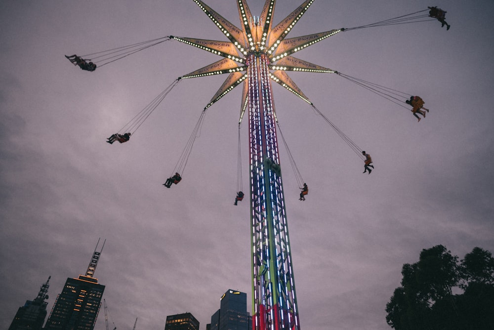 a ferris wheel with people on it in a city